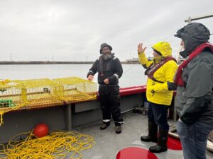 Lobster Fishermen in Canada on Boat with Lobster Pots and tracking device